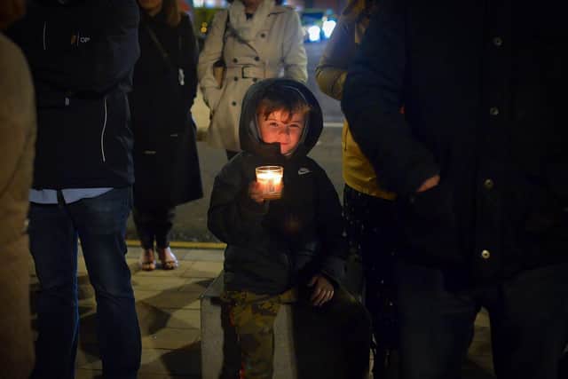 A young boy carries a lighted candle at a vigil, held in Guildhall Square on Monday evening, to remember those who died in the Creeslough tragedy on Friday afternoon last.  Photo: George Sweeney.  DER2241GS – 51
