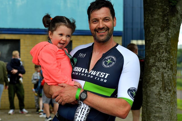 David McGonigle is congratulated by his daughter after completing the Liam Ball Triathlon on Sunday morning.