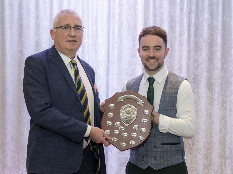 Sion Mills' Rian McKelvey receives the League One batting award from Nw Chairman, Brian Dougherty.