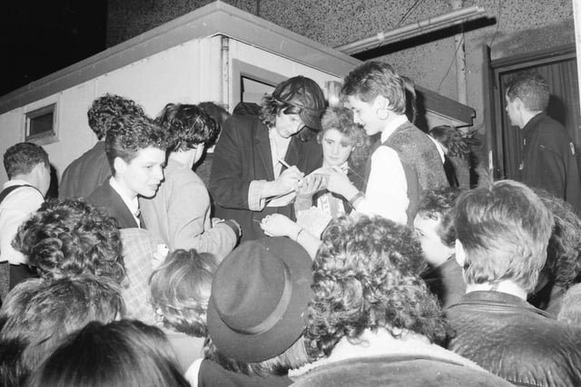 Mike Scott of The Waterboys signing autographs for fans.