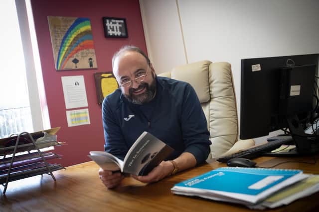 Derry poet Feargal Friel pictured at Hollybush Primary School this week with the first copy of his book 'The In-Between' (Photo: JIm McCafferty Photography)