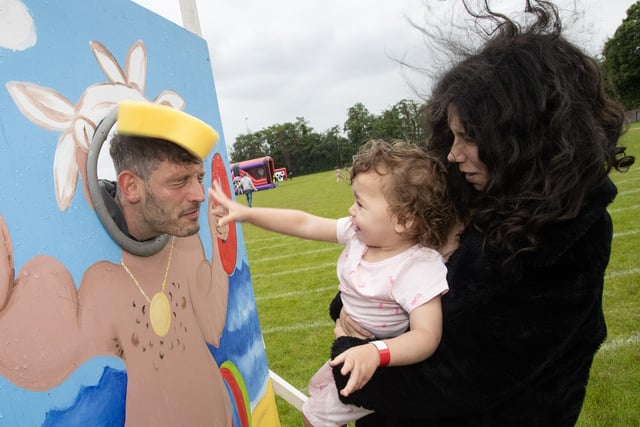 GOTCHA MR. LOWRY!. . . .Two years old Maelyn Harkin ably assisted by her mother Ashlyn makes sure Mr Lowry gets splashed during the Holy Child PS Summer Fair on Friday last. (Photo: Jim McCafferty Photography)