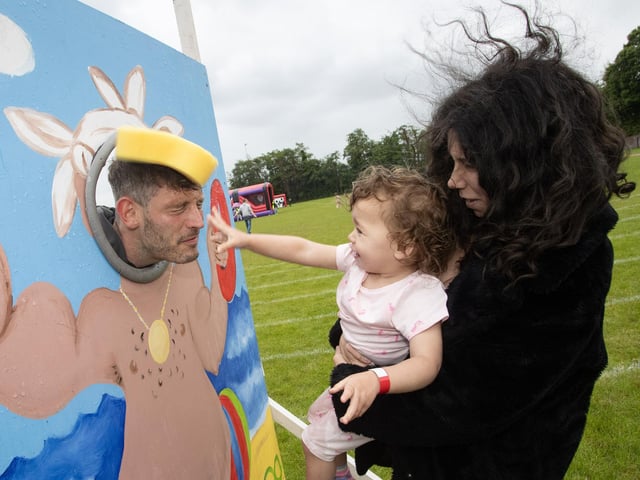 GOTCHA MR. LOWRY!. . . .Two years old Maelyn Harkin ably assisted by her mother Ashlyn makes sure Mr Lowry gets splashed during the Holy Child PS Summer Fair on Friday last. (Photo: Jim McCafferty Photography)