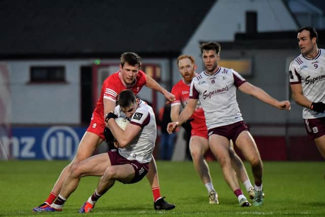 Derry’s Anton Tohill contests possession with Galway’s Matthew Tierney. Photo: George Sweeney