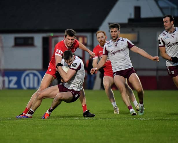 Derry’s Anton Tohill contests possession with Galway’s Matthew Tierney. Photo: George Sweeney