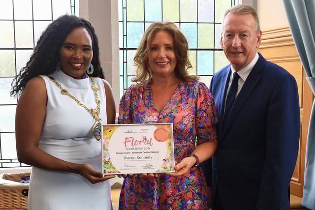Mayor Lilian Seenoi Barr presents the City Centre Initiative Floral Competition 2024 Bronze Award (Residential Garden Category) to Sharon Kennedy. Included is Jim Roddy, CEO of City Centre Initiative. (Photo - Tom Heaney, nwpresspics)