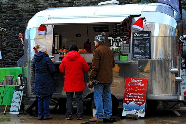 People getting food at the Christmas Market in Guildhall Square on Friday afternoon. Photo: George Sweeney. DER2250GS – 64