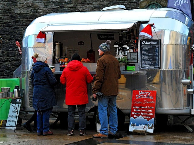 People getting food at the Christmas Market in Guildhall Square on Friday afternoon. Photo: George Sweeney. DER2250GS – 64