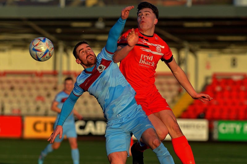 February 2023: Calvin McCallion gets the ball ahead of Ballyclare Comrades’ Bobby Higgins as 'Stute continue their bid to remain the Championship. Photo: George Sweeney