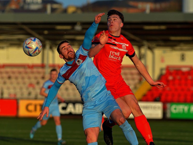 February 2023: Calvin McCallion gets the ball ahead of Ballyclare Comrades’ Bobby Higgins as 'Stute continue their bid to remain the Championship. Photo: George Sweeney
