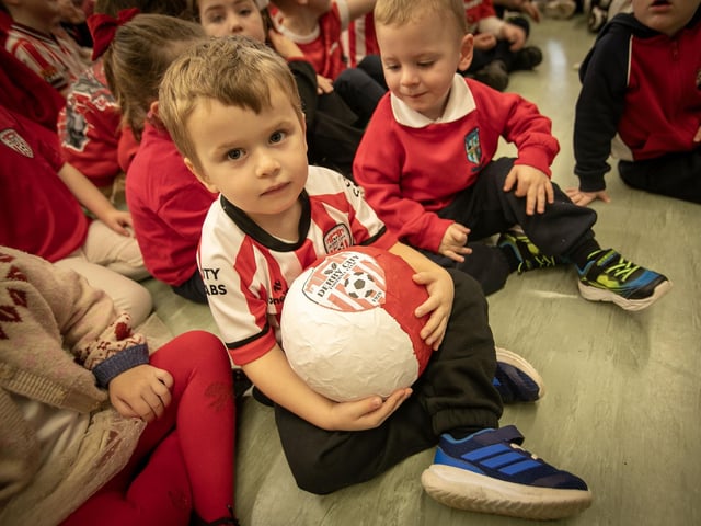 One of the younger pupils holds on tight to this football.