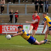 Niall Higgins and David Murray of Roscommon try to close down Derry’s Lachlan Murray.  Photo: George Sweeney