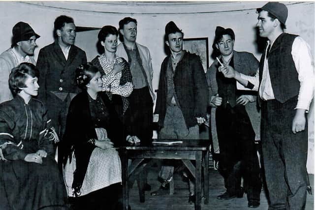 Author Gerry Downey, third from right, in the 1965 Cumann Drámaíochta Chraobh Sheáin Uí Dhubhláin production of An Strainséir Dubh. Peter Mullan (second from left at back) and Therese Martin (back right), would also both go on to perform with the Theatre Club. Risteard Mac Gabhann (front left) would become an active member of the Theatre Action Group and a director of the Millennium Forum, while Peter Gallagher (front right) would become CEO of the North West Regional College and establish the Performing Arts Academy with Gerry.