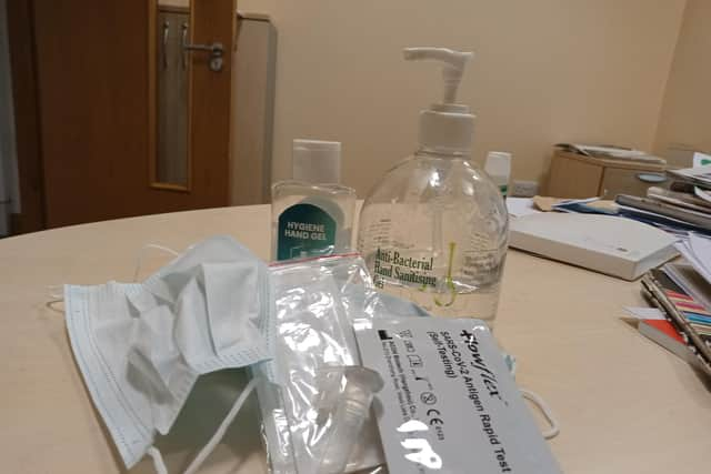 Covid test kit, hand sanitiser and mask.