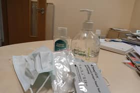 Covid test kit, hand sanitiser and mask.