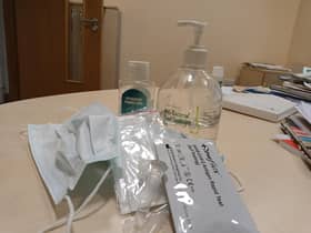 Covid test kit, hand sanitiser and mask.
