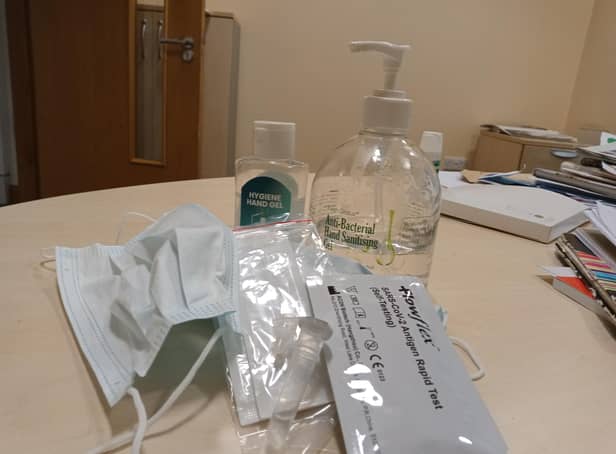 Covid test kit, hand sanitiser and mask.