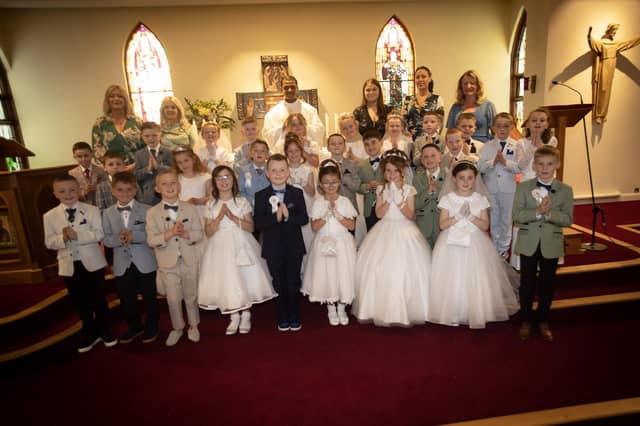 ST. PAUL'S FIRST COMMUNION . . . . .Children from St. Paul's Primary School, Slievemore who received the Sacrament of First Holy Communion from Fr. Roni Zacharias, CC,at St. Joseph's Church, Galliagh on Friday afternoon. Included at back are teachers and classroom assistants.. (Photo: Jim McCafferty Photography)