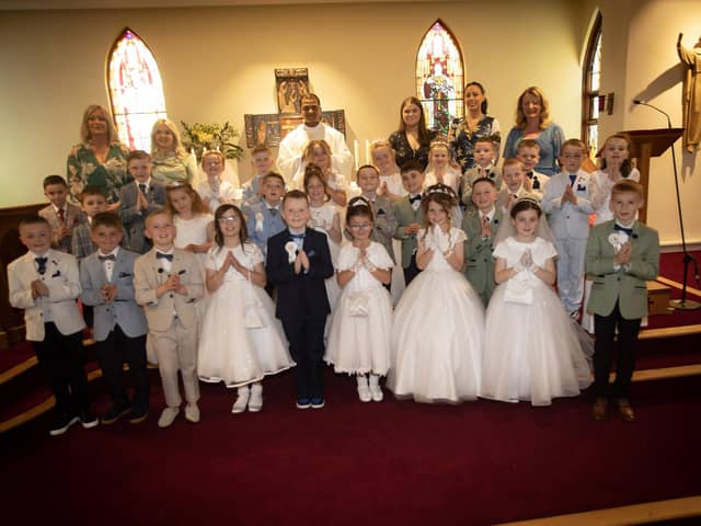 ST. PAUL'S FIRST COMMUNION . . . . .Children from St. Paul's Primary School, Slievemore who received the Sacrament of First Holy Communion from Fr. Roni Zacharias, CC,at St. Joseph's Church, Galliagh on Friday afternoon. Included at back are teachers and classroom assistants.. (Photo: Jim McCafferty Photography)