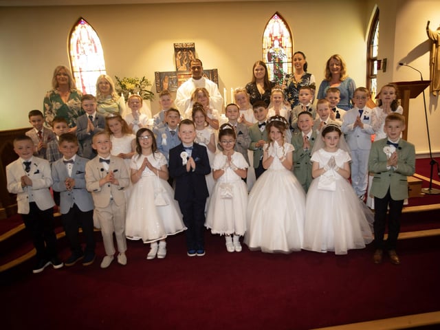 ST. PAUL'S FIRST COMMUNION . . . . .Children from St. Paul's Primary School, Slievemore who received the Sacrament of First Holy Communion from Fr. Roni Zacharias, CC,at St. Joseph's Church, Galliagh on Friday afternoon. Included at back are teachers and classroom assistants.. (Photo: Jim McCafferty Photography)