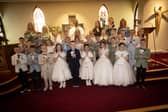 ST. PAUL'S FIRST COMMUNION . . . . .Children from St. Paul's Primary School, Slievemore who received the Sacrament of First Holy Communion from Fr. Roni Zacharias, CC,at St. Joseph's Church, Galliagh on Friday afternoon. Included at back are teachers and classroom assistants.. (Photo: Jim McCafferty Photography)