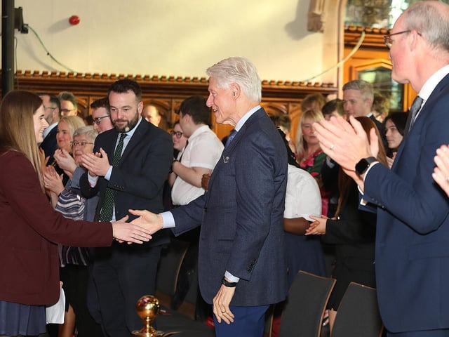 Ellianna McBride from Foyle College shakes hands with Bill Clinton