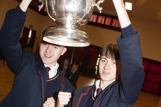 Two Oakgrove Integrated College students take time to get a picture with the FAI Cup.
