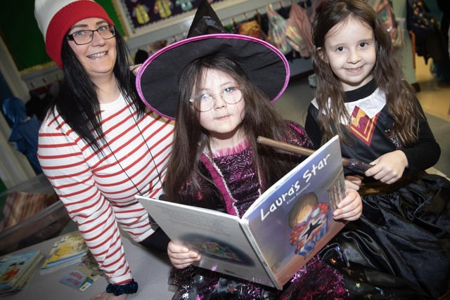 Classroom Assistant Miss Ward with pupils Ayda and Sofia getting in some reading to celebrate World Book Day at Greenhaw PS.