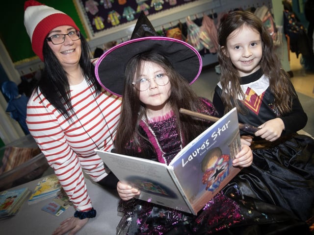 Classroom Assistant Miss Ward with pupils Ayda and Sofia getting in some reading to celebrate World Book Day at Greenhaw PS.