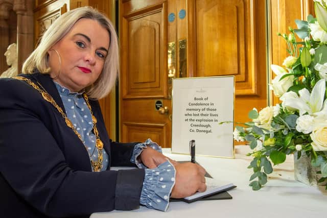Councillor Sandra Duffy Mayor of Derry City and Strabane District Council opens a Book of Condolence in the Guildhall in Memory of the ten victims of the Cresslough explosion. Picture Martin McKeown. 10.10.22