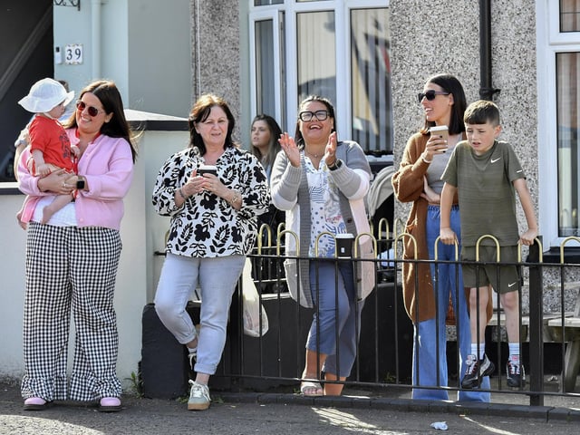 People enjoy the sunshine and the sounds of the Top Tier Brass Band playing in Meenan Square. Photo: George Sweeney