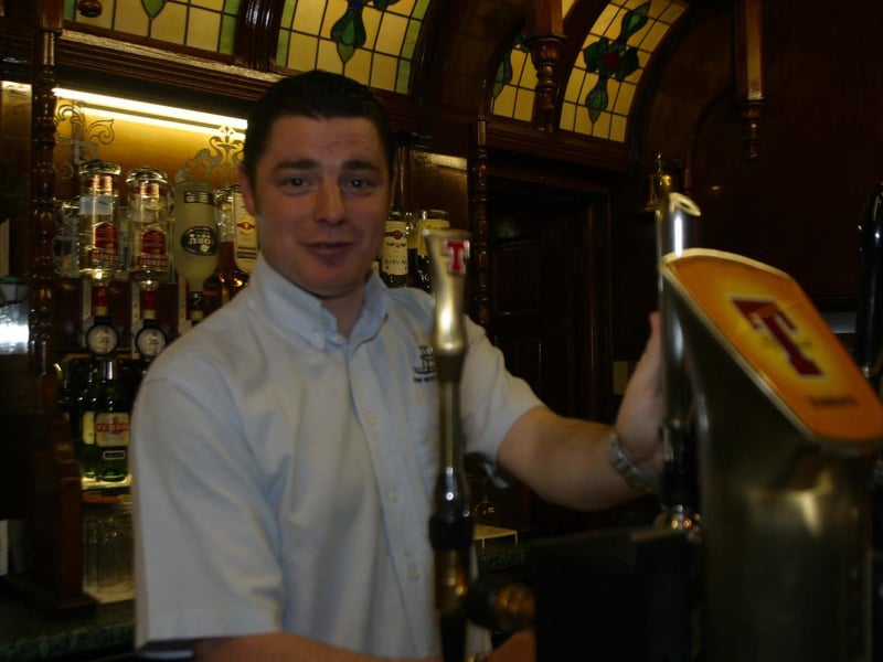 Ruari Mc Eleney Manager of the Rocking Chair pulls a pint for a local.