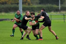 City of Derry’s Alex McDonnell is tackled by Connemara pair Ian Heanue and Shane Sweeney during their All Ireland Junior Cup game at Judges Road on Saturday afternoon. Photo: George Sweeney