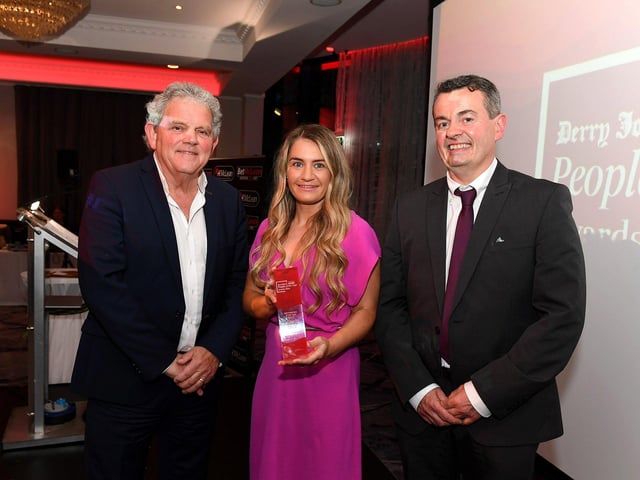 Sports Person of the Year Award winner Gemma Thompson receives her award from BetMcLean Area manager John Gallagher and compere Adrian Logan. Photo: George Sweeney
