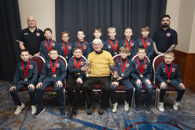 John ‘Jobby’ Crossan presenting the U10 Summer and Winter Cups to Clooney FC at the Annual Awards in the City Hotel on Friday night last. Included are coaches David Thompson and Michael Robinson.