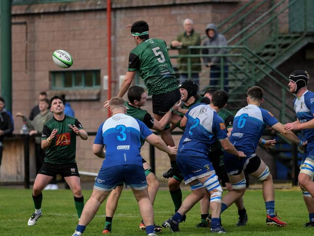 City of Derry’s Cein McColgan (5) offloads the ball to Jamie Millar. Photo: George Sweeney