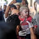 KHAN YOUNIS, GAZA - OCTOBER 16: Palestinian children injured during Israeli raids in the southern Gaza Strip arrive on October 16, 2023 in Khan Yunis, Gaza. Gazans are evacuating to the south following warnings to do so from the Israeli government, ahead of an expected Israeli ground offensive. Israel has sealed off Gaza and launched sustained retaliatory air strikes, which have killed at least 2,500 people with more than 400,000 displaced, after a large-scale attack by Hamas. On October 7, the Palestinian militant group Hamas launched a surprise attack on Israel from Gaza by land, sea, and air, killing over 1,300 people and wounding around 2,800. Israeli soldiers and civilians have also been taken hostage by Hamas and moved into Gaza. The attack prompted a declaration of war by Israeli Prime Minister Benjamin Netanyahu and the announcement of an emergency wartime government. (Photo by Ahmad Hasaballah/Getty Images)