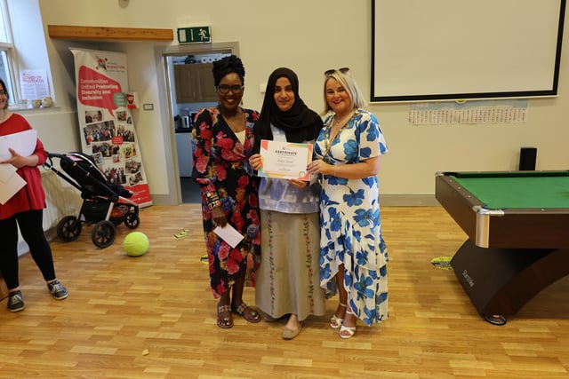 Lilian Seenoi Barr and Mayor Sandra Duffy presenting Fadwa Saeed with a certificate for her volunteering efforts.