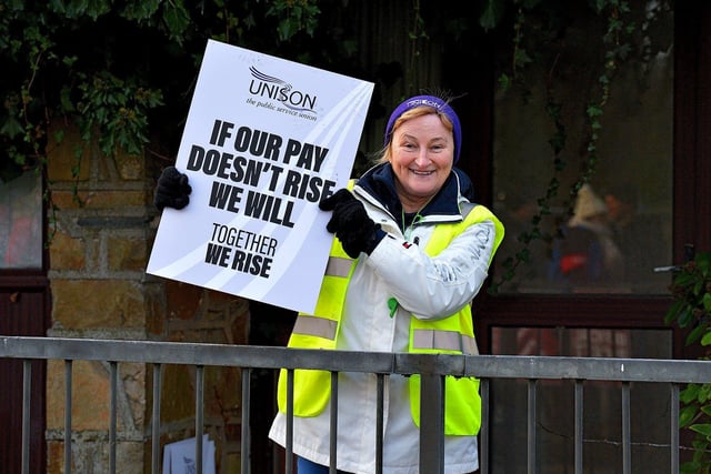 A striking health and social care worker pickets outside Gransha on Monday morning. Photo: George Sweeney. DER2250GS – 11
