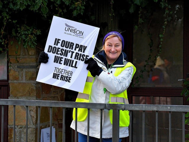 A striking health and social care worker pickets outside Gransha on Monday morning. Photo: George Sweeney. DER2250GS – 11