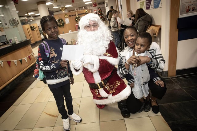 Santa Claus receiving letters from Kareemai, Koke and Faiz Ali at the Derry Credit Union Santa Saturday event. : .