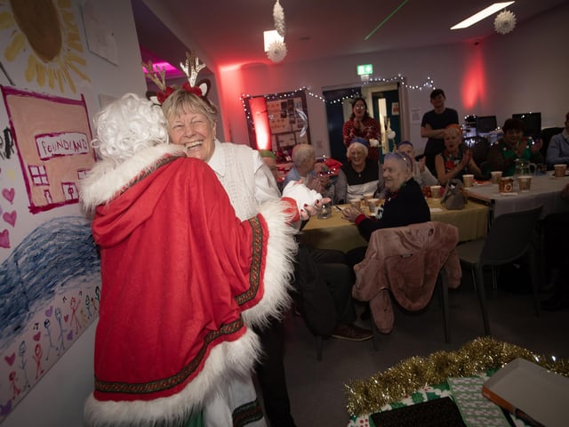Jeanette Warke, Leader, Cathedral Youth Club thanks Mrs. Claus at last week's Fountain Senior Citizens Christmas Party.