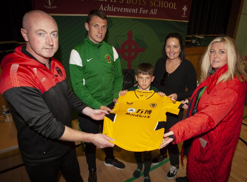 Winners of the Lee Harkin jersey (currently signed by Premiership club Wolverhampton Wanderers) at the Sean O’Kane Memorial Cup on Sunday was Foyle Harps Jack Strunks. Included are Christy McGeehan, organiser, Emmett McGinty, teacher/organiser, Ciara McGlynn and Mrs. Ciara Deane, principal, St. Joseph’s Boys School.