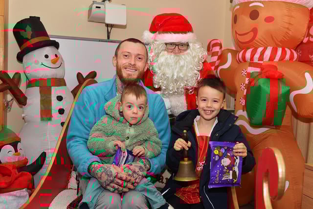 Daryl and his sons Ollie and AJ pictured with Santa at the Galliagh Community Christmas Craft Fair and Wonderland on Saturday afternoon. Photo: George Sweeney
