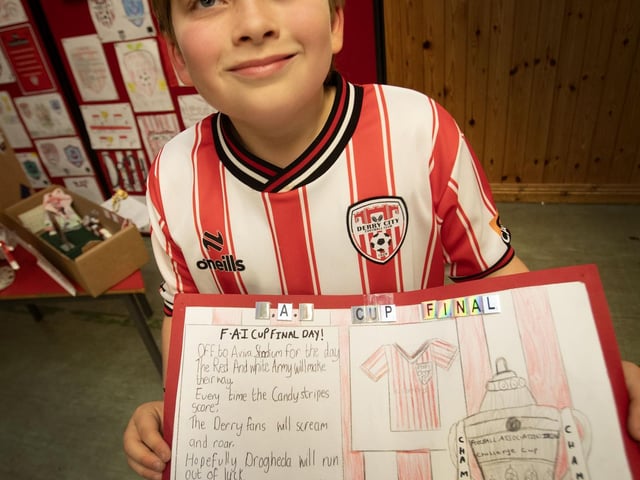 Hollybush PS pupil Finn proudly presents his joint winning entry for the Derry City poster competition.