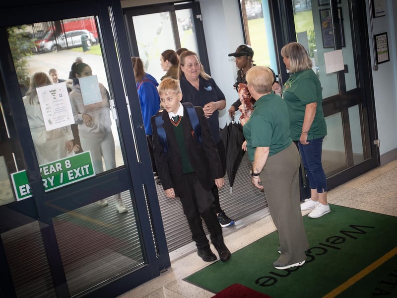 Year 8 students make their way through the doors of St. Joseph's on Friday morning, accompanied by parents.