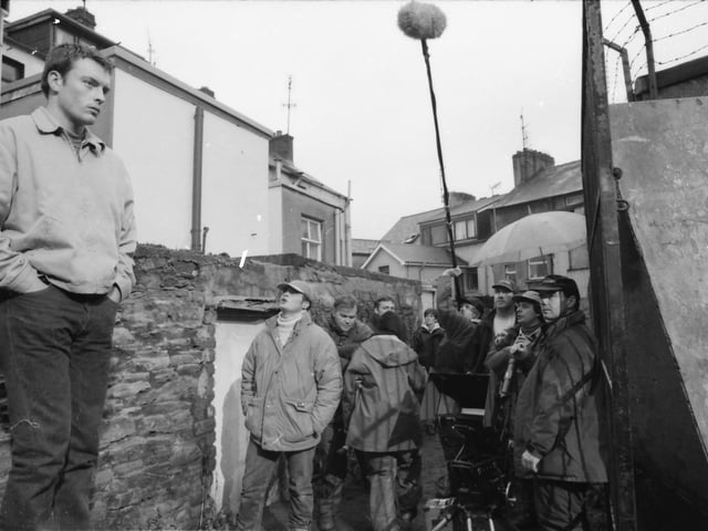 Toby Stevens gets direction on the set of 'Sunset Heights'.