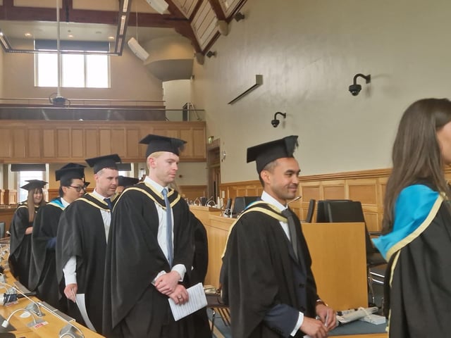 Graduates make their way from the Council chamber to the Main Hall in the Guildhall to complete their graduation.