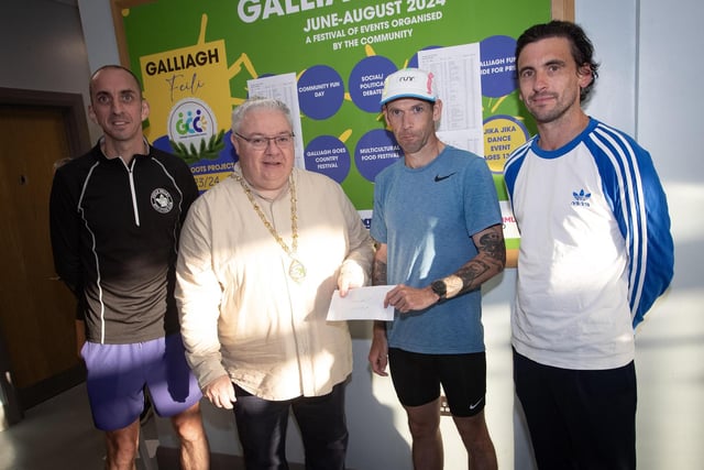 MEN'S WINNERS. . . The Deputy Mayor, Darren Guy presenting the Galliagh Feile 5k winner Matthew McLaughlin with his prize on Friday night. On left is Gary McCay, 2nd, and on right, Sean O'Donnell, 3rd. (Photos: Jim McCafferty Photography)