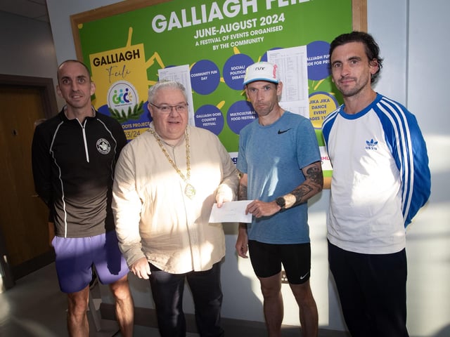 MEN'S WINNERS. . . The Deputy Mayor, Darren Guy presenting the Galliagh Feile 5k winner Matthew McLaughlin with his prize on Friday night. On left is Gary McCay, 2nd, and on right, Sean O'Donnell, 3rd. (Photos: Jim McCafferty Photography)